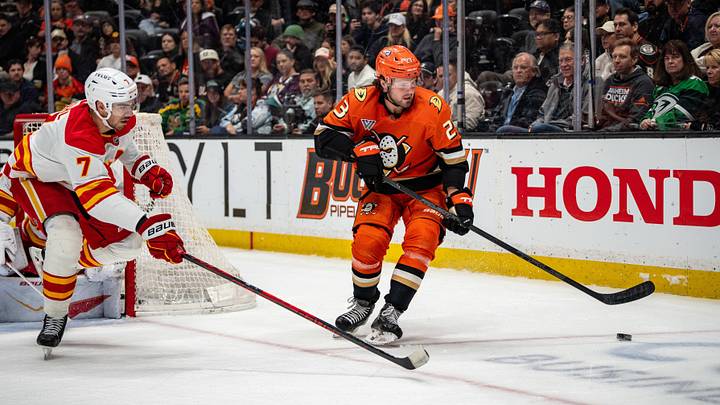 Apr 4, 2026; Anaheim, California, USA;  Anaheim Ducks center Mason McTavish (23) skates with the puck against Calgary Flames defenseman Kevin Bahl (7) during the second period at Honda Center. Mandatory Credit: Corinne Votaw-Imagn Images