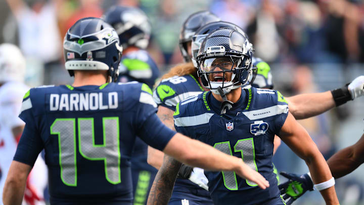 Nov 9, 2025; Seattle, Washington, USA;  Seattle Seahawks wide receiver Jaxon Smith-Njigba (11) celebrates with Seattle Seahawks quarterback Sam Darnold (14) after scoring a touchdown during the first quarter against the Arizona Cardinals at Lumen Field. Mandatory Credit: Steven Bisig-Imagn Images
