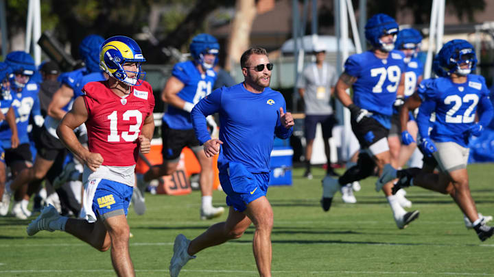 Jul 23, 2025; Los Angeles, CA, USA; Los Angeles Rams coach Sean McVay runs with quarterback Stetson Bennett (13) during training camp at Loyola Marymount University. Mandatory Credit: Kirby Lee-Imagn Images Jul 23, 2025; Los Angeles, CA, USA; Los Angeles Rams coach Sean McVay runs with quarterback Stetson Bennett (13) during training camp at Loyola Marymount University. Mandatory Credit: Kirby Lee-Imagn Images