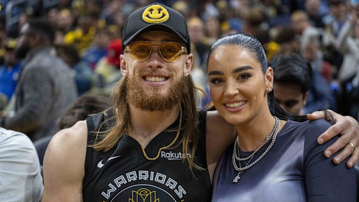 Jan 30, 2024; San Francisco, California, USA;  San Francisco 49ers tight end George Kittle and wife Claire Kittle at a game between Golden State Warriors and Philadelphia 76ers during the second quarter at Chase Center.