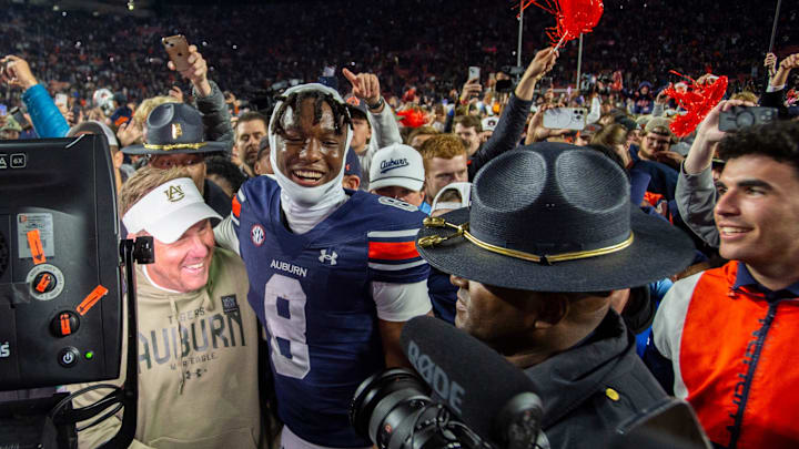 Auburn Tigers head coach Hugh Freeze and wide receiver Cam Coleman (8) hug after the game as Auburn Tigers take on Texas A&M Aggies at Jordan-Hare Stadium in Auburn, Ala., on Saturday, Sept. 7, 2024. Auburn Tigers defeated Texas A&M Aggies 43-41 in fourth overtime.