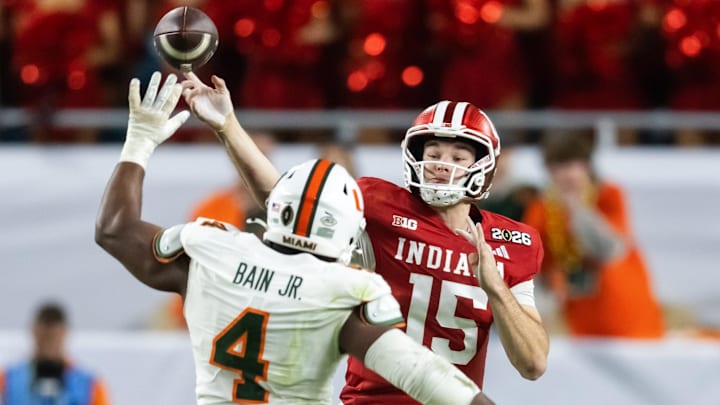Jan 19, 2026; Miami Gardens, FL, USA; Miami Hurricanes defensive lineman Rueben Bain Jr. (4) defends against Indiana Hoosiers quarterback Fernando Mendoza (15) during the College Football Playoff National Championship game at Hard Rock Stadium. Mandatory Credit: Mark J. Rebilas-Imagn Images