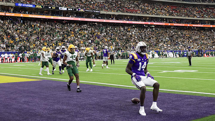 Dec 31, 2024; Houston, TX, USA;  LSU Tigers tight end Trey'Dez Green (14) celebrates his touchdown reception against the Baylor Bears in the second quarter at NRG Stadium. Mandatory Credit: Thomas Shea-Imagn Images