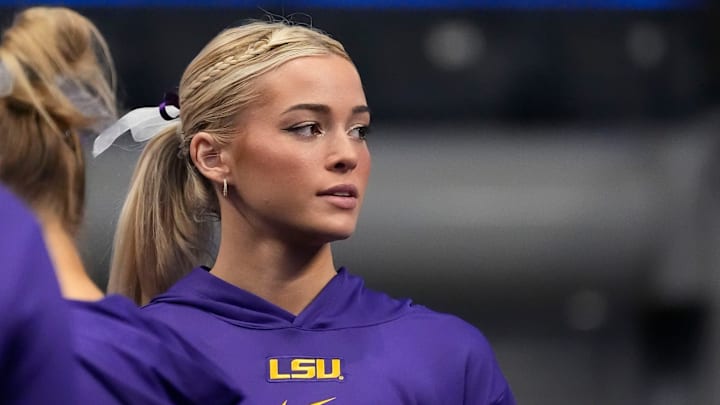 Mar 22, 2025; Birmingham AL, USA; LSU gymnast Livvy Dunne stretches with teammates before Session 2 of the SEC Gymnastics Tournament at Legacy Arena in Birmingham, Alabama.