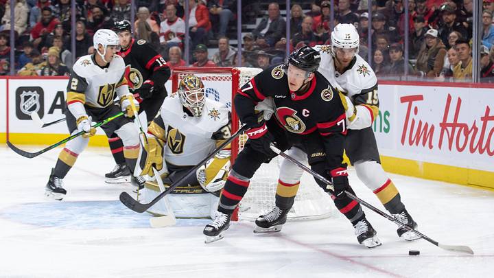 Nov 21, 2024; Ottawa, Ontario, CAN; Ottawa Senators left wing Brady Tkachuk (7) moves the puck away from Vegas Golden Knights  defenseman Noah Hanifin (15) in the first period at the Canadian Tire Centre. Mandatory Credit: Marc DesRosiers-Imagn Images