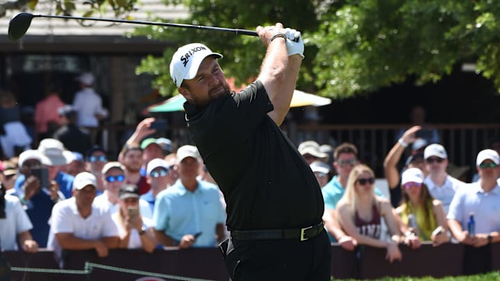 Shane Lowry of Ireland hits his tee shot on the first hole...
