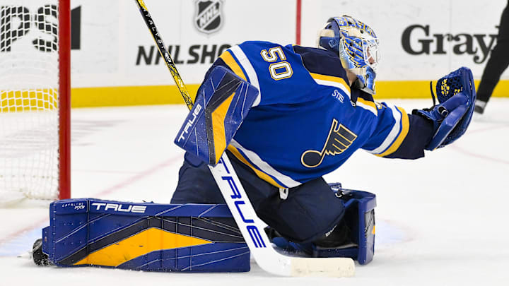 Nov 21, 2024; St. Louis, Missouri, USA;  St. Louis Blues goaltender Jordan Binnington (50) defends the net against the San Jose Sharks during the third period at Enterprise Center. Mandatory Credit: Jeff Curry-Imagn Images