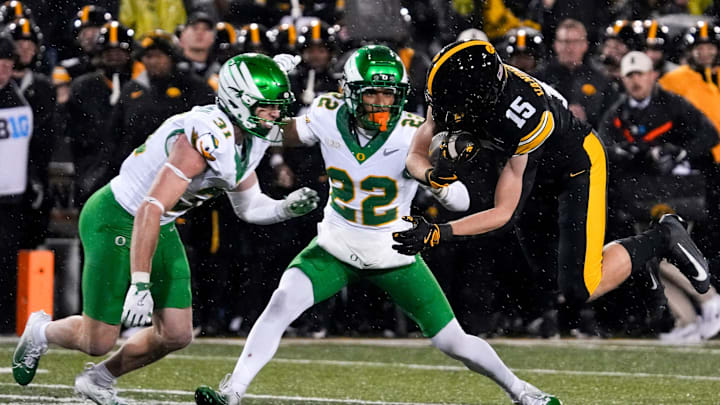 Iowa Hawkeyes wide receiver Reece Vander Zee (15) is stopped by Oregon Ducks defensive back Dillon Thieneman Iowa Hawkeyes wide receiver Reece Vander Zee (15) is stopped by Oregon Ducks defensive back Dillon Thieneman