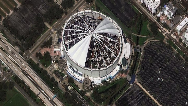 The roof of Tropicana Field, home of the Tampa Bay Rays MLB team, was torn off by Hurricane Milton's powerful winds. Satellite imagery from Maxar shows the destruction on Oct. 10, 2024. Prior to landfall, the stadium was converted into a base camp for emergency responders. The roof of Tropicana Field, home of the Tampa Bay Rays MLB team, was torn off by Hurricane Milton's powerful winds. Satellite imagery from Maxar shows the destruction on Oct. 10, 2024. Prior to landfall, the stadium was converted into a base camp for emergency responders.