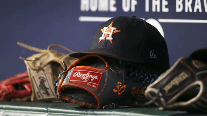 A detailed view of the hat and glove of Houston Astros A detailed view of the hat and glove of Houston Astros