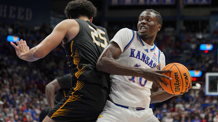 Oct 28, 2025; Lawrence, KS, USA; Kansas Jayhawks forward Flory Bidunga (40) drives against Fort Hays State Tigers forward Juju Ramirez (25) during the second half at Allen Fieldhouse. Mandatory Credit: Jay Biggerstaff-Imagn Images