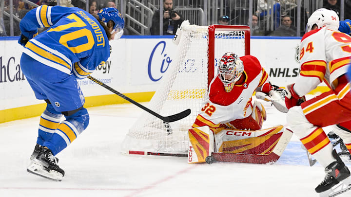 Nov 11, 2025; St. Louis, Missouri, USA; Calgary Flames goaltender Dustin Wolf (32) makes a save against St. Louis Blues center Oskar Sundqvist (70) during the second period at Enterprise Center. Mandatory Credit: Jeff Curry-Imagn Images