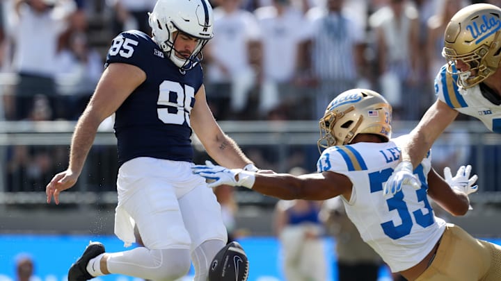 Oct 5, 2024; University Park, Pennsylvania, USA; Penn State Nittany Lions punter Riley Thompson (95) punts the ball as UCLA Bruins linebacker Ty Lee (33) attempts to block during the fourth quarter at Beaver Stadium. Mandatory Credit: Matthew O'Haren-Imagn Images Oct 5, 2024; University Park, Pennsylvania, USA; Penn State Nittany Lions punter Riley Thompson (95) punts the ball as UCLA Bruins linebacker Ty Lee (33) attempts to block during the fourth quarter at Beaver Stadium. Mandatory Credit: Matthew O'Haren-Imagn Images
