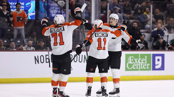 Tyson Foerster, Travis Sanheim, Travis Konecny celebrate in a game versus the Arizona Coyotes