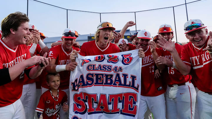 Iowa City High players celebrate with their state tournament qualifier banner after defeating Indianola during a regional final baseball game July 16, 2025 at Duane Banks Field in Iowa City, Iowa.