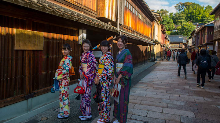 Street scene with young Japanese women in Kimonos in the...