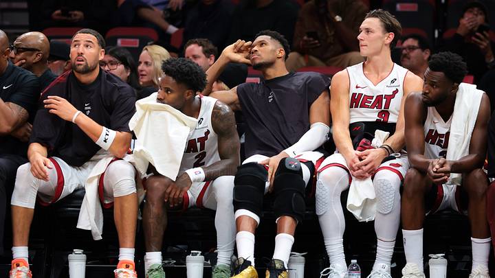 Oct 21, 2026; Miami, Florida, USA; Miami Heat guard Klay Thompson (11), guard Davion Mitchell (2), forward Giannis Antetokounmpo (7), guard Pelle Larsson (9) and forward Andrew Wiggins (22) look on from the bench against the Minnesota Timberwolves during the fourth quarter at Kaseya Center. Mandatory Credit: Sam Navarro-Imagn Images