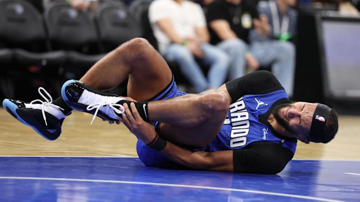 Orlando Magic guard Jalen Suggs (4) goes down with an injury against the Oklahoma City Thunder in the second quarter at Kia Center.