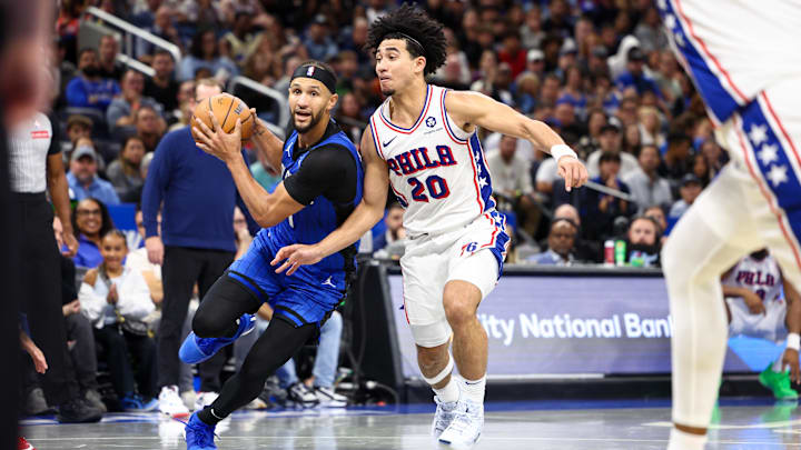 Orlando Magic guard Jalen Suggs (4) drives to the basket past Philadelphia 76ers guard Jared McCain (20) in the fourth quarter at Kia Center.