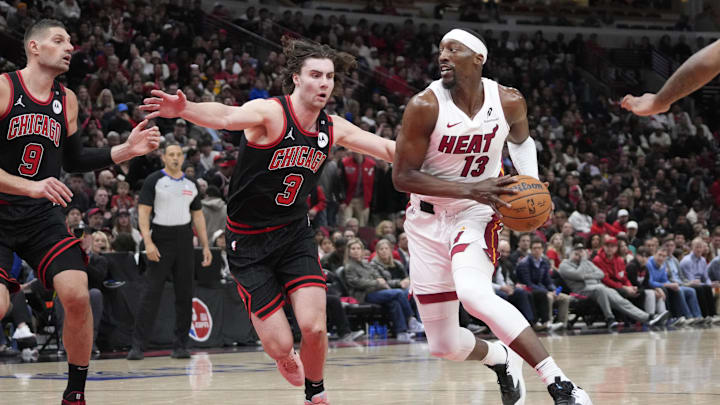 Apr 16, 2025; Chicago, Illinois, USA; Chicago Bulls guard Josh Giddey (3) defends Miami Heat center Bam Adebayo (13) during the second half at United Center. Mandatory Credit: David Banks-Imagn Images