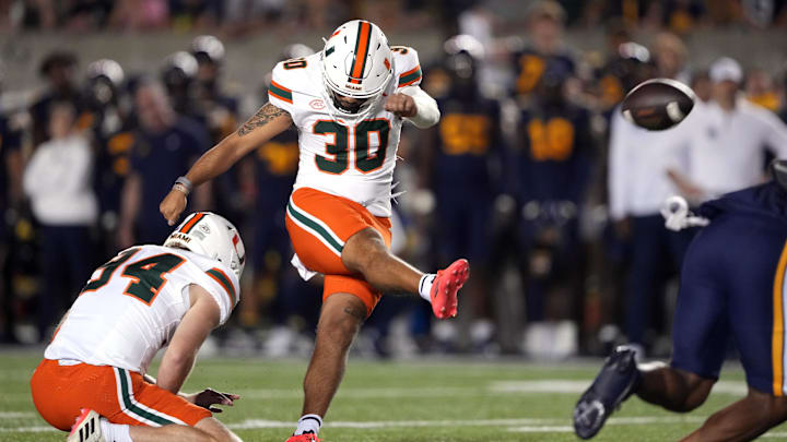 Miami Hurricanes place kicker Andres Borregales (30) kicks an extra point against the California Golden Bears during the fourth quarter at California Memorial Stadium. 