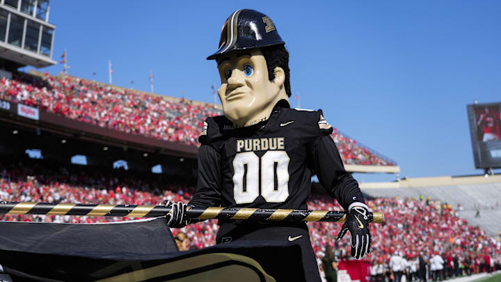 Purdue Boilermakers mascot Purdue Pete holds a Purdue flag Purdue Boilermakers mascot Purdue Pete holds a Purdue flag