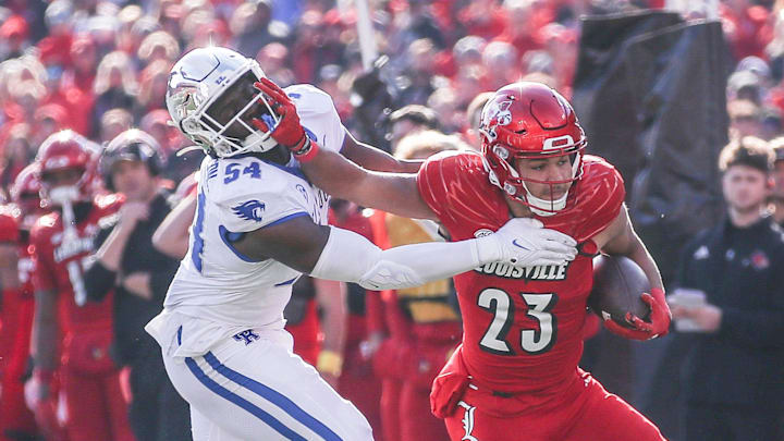 Kentucky Wildcats linebacker D'Eryk Jackson (54) tries to stop Louisville Cardinals running back Isaac Guerendo (23) in the first half of the 2023 Governor's Cup game in Louisville. Nov. 24, 2023 Kentucky Wildcats linebacker D'Eryk Jackson (54) tries to stop Louisville Cardinals running back Isaac Guerendo (23) in the first half of the 2023 Governor's Cup game in Louisville. Nov. 24, 2023