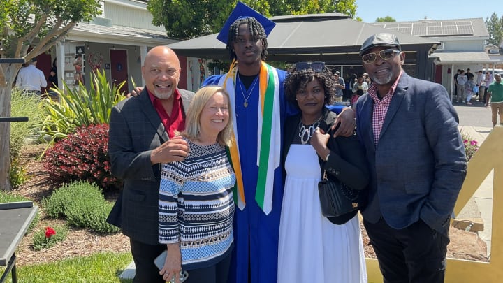 Zoom Diallo, with family members, graduates from high school. Zoom Diallo, with family members, graduates from high school.