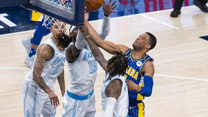 May 15, 2021; Indianapolis, Indiana, USA; Indiana Pacers guard Edmond Sumner (5) shoots the ball while Los Angeles Lakers center Montrezl Harrell (15) defends in the second  quarter at Bankers Life Fieldhouse. Mandatory Credit: Trevor Ruszkowski-Imagn Images