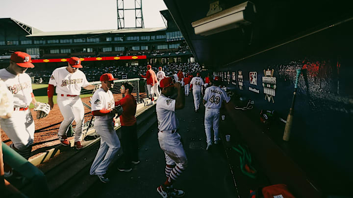 Memphis Redbirds players enter the dugout during the opening day game against the Charlotte Knights on Friday, March 29, 2024 at AutoZone Park in Memphis, Tenn.