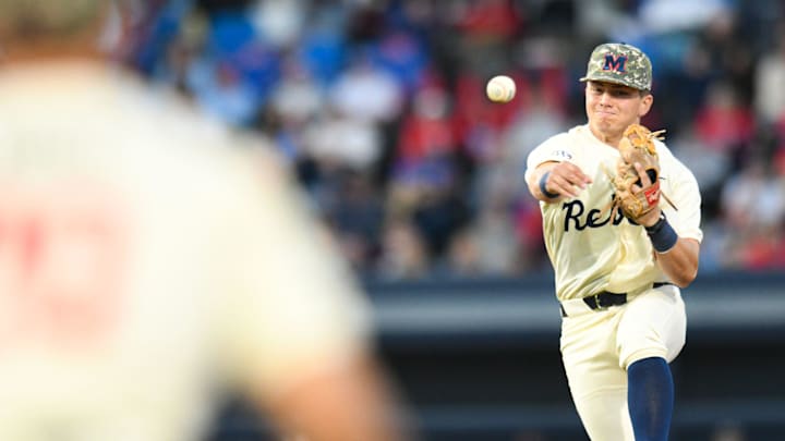 Ole Miss infielder Luke Hill (7) fields, steps on second for an out, and throws to first for a double play in the 2nd inning at Swayze Field in Oxford, Miss., on Friday, Apr. 12, 2024.