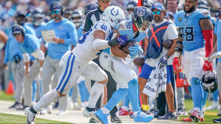 Sep 21, 2025; Nashville, Tennessee, USA; Tennessee Titans running back Tony Pollard (20) is pushed out of bounds by Indianapolis Colts linebacker Joe Bachie (48) during the third quarter at Nissan Stadium. Mandatory Credit: Andrew Nelles-USA TODAY Network via Imagn Images