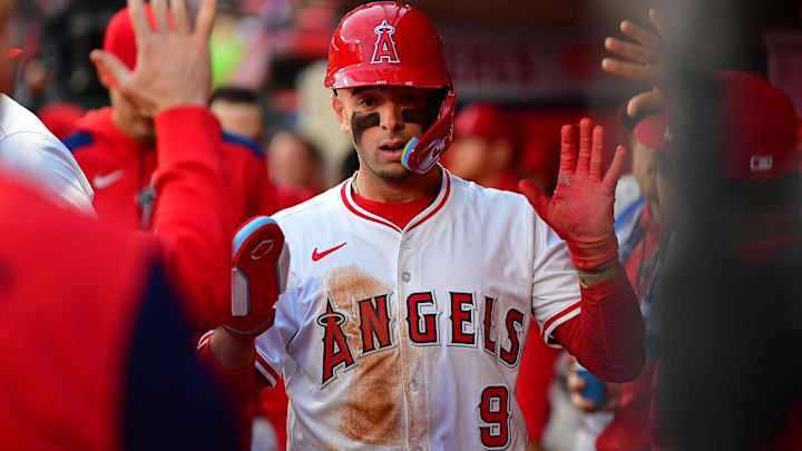 Apr 18, 2025; Anaheim, California, USA; Los Angeles Angels shortstop Zach Neto (9) is greeted after scoring a run against the San Francisco Giants during the second inning at Angel Stadium. Mandatory Credit: Gary A. Vasquez-Imagn Images