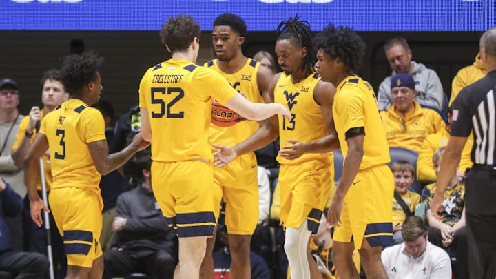 Jan 10, 2026; Morgantown, West Virginia, USA; West Virginia Mountaineers guard Chance Moore (13) celebrates with teammates after a play during the first half against the Kansas Jayhawks at Hope Coliseum. 