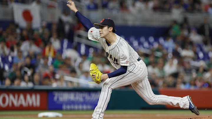 Mar 20, 2023; Miami, Florida, USA; Japan starting pitcher Roki Sasaki (14) delivers a pitch during the first inning against Mexico at LoanDepot Park. Mandatory Credit: Sam Navarro-Imagn Images