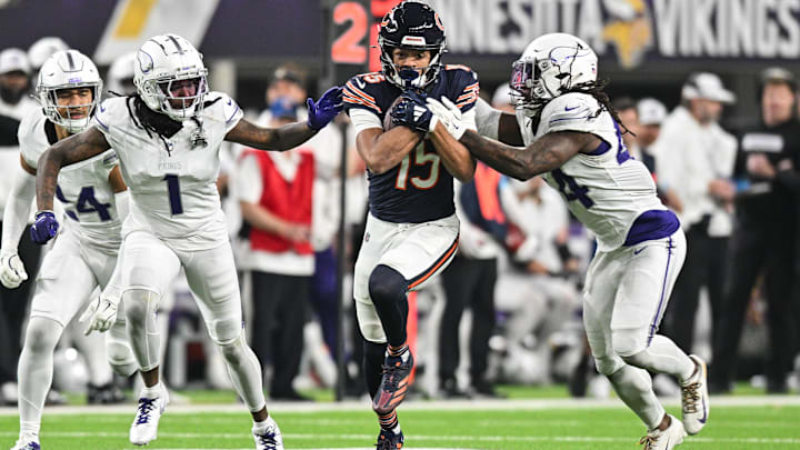 Rome Odunze gains yardage after the catch against Vikings safety Josh Metellus (right) and cornerback Shaquill Griffin.