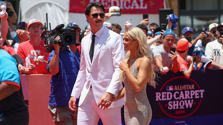 Jul 16, 2024; Arlington, Texas, USA; Pittsburgh Pirates pitcher Paul Skenes walks the red carpet with LSU gymnast and girlfriend Livvy Dunne before the 2024 MLB All-Star game at Globe Life Field. Mandatory Credit: Kevin Jairaj-Imagn Images