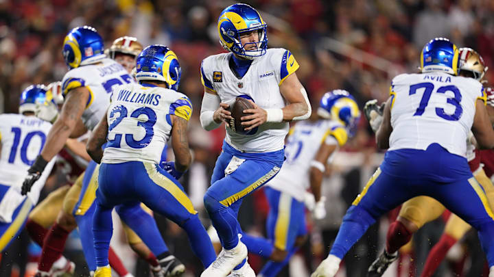 Dec 12, 2024; Santa Clara, California, USA; Los Angeles Rams quarterback Matthew Stafford (9) holds onto the ball against the San Francisco 49ers in the fourth quarter at Levi's Stadium. Mandatory Credit: Cary Edmondson-Imagn Images