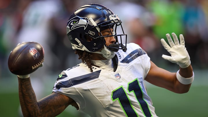 Oct 20, 2024; Atlanta, Georgia, USA; Seattle Seahawks wide receiver Jaxon Smith-Njigba (11) throws a pass against the Atlanta Falcons in the second quarter at Mercedes-Benz Stadium.