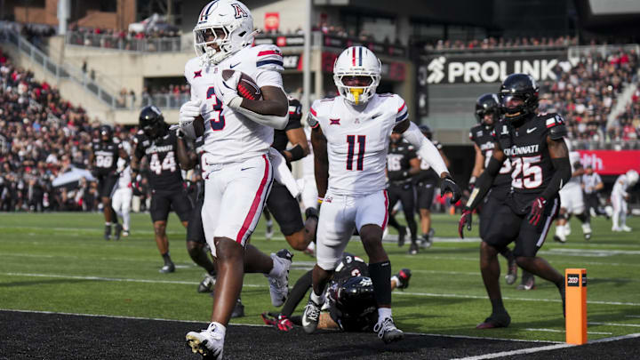 Nov 15, 2025; Cincinnati, Ohio, USA;  Arizona Wildcats running back Kedrick Reescano (3) carries the ball for a touchdown against the Cincinnati Bearcats in the second half at Nippert Stadium. Mandatory Credit: Aaron Doster-Imagn Images