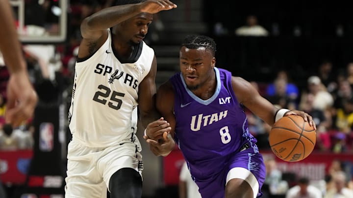 Jul 14, 2025; Las Vegas, NV, USA;  Utah Jazz guard Isaiah Collier (8) drives the ball against San Antonio Spurs forward David Jones-Garcia (25) during the first half of a NBA basketball game at the Thomas & Mack Center. Mandatory Credit: Lucas Peltier-Imagn Images