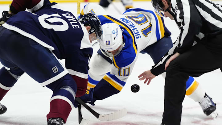 Mar 29, 2025; Denver, Colorado, USA; Colorado Avalanche center Charlie Coyle (10) and St. Louis Blues center Brayden Schenn (10) take a face-off in the third period at Ball Arena. Mandatory Credit: Ron Chenoy-Imagn Images