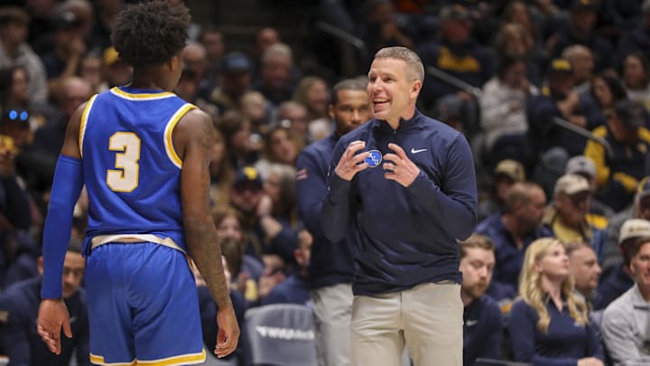 Jan 31, 2026; Morgantown, West Virginia, USA; West Virginia Mountaineers head coach Ross Hodge talks with West Virginia Mountaineers guard Honor Huff (3) during the first half against the Baylor Bears at Hope Coliseum. Mandatory Credit: Ben Queen-Imagn Images
