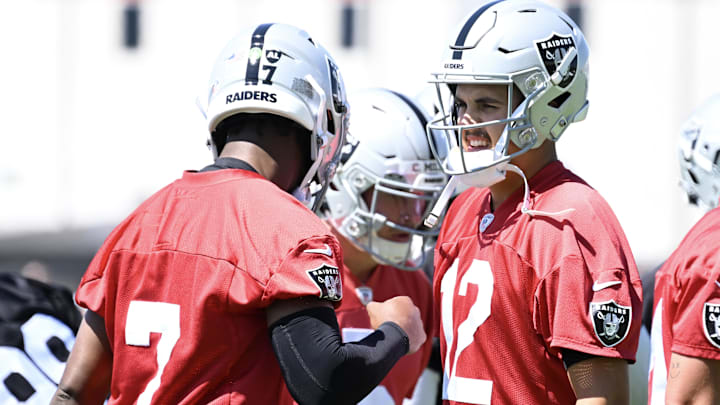Jun 10, 2025; Henderson, NV, USA; Las Vegas Raiders quarterback Geno Smith (7) and quarterback Aidan O'Connell (12) rest between stretches during Las Vegas Raiders Minicamp at Intermountain Health Performance Center. Mandatory Credit: Candice Ward-Imagn Images