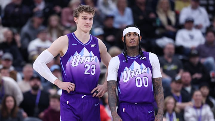 Dec 28, 2024; Salt Lake City, Utah, USA; Utah Jazz forward Lauri Markkanen (23) and guard Jordan Clarkson (00) watch the Philadelphia 76ers shoot free throws during the fourth quarter at Delta Center. Mandatory Credit: Rob Gray-Imagn Images