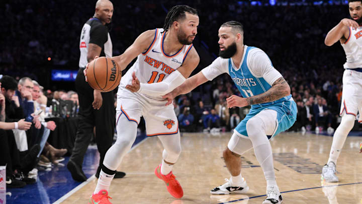 Dec 5, 2024; New York, New York, USA; New York Knicks guard Jalen Brunson (11) passes the ball as Charlotte Hornets forward Cody Martin (11) defends during the second half at Madison Square Garden. Mandatory Credit: John Jones-Imagn Images