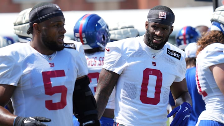 Jul 26, 2024; East Rutherford, NJ, USA; New York Giants linebacker Kayvon Thibodeaux (5) and New York Giants linebacker Brian Burns (0) break on the sideline during training camp at Quest Diagnostics Training Center. Mandatory Credit: Lucas Boland-Imagn Images