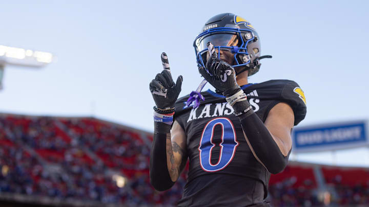 Nov 9, 2024; Kansas City, Missouri, USA; Kansas Jayhawks wide receiver Quentin Skinner (0) celebrates after scoring a touchdown during the second quarter against the Iowa State Cyclones at GEHA Field at Arrowhead Stadium. 