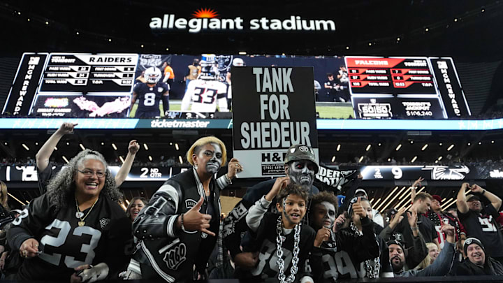 Dec 16, 2024; Paradise, Nevada, USA; Las Vegas Raiders fans hold a sign that reads Tank for Shedeur Sanders during the game against the Atlanta Falcons at Allegiant Stadium. Mandatory Credit: Kirby Lee-Imagn Images