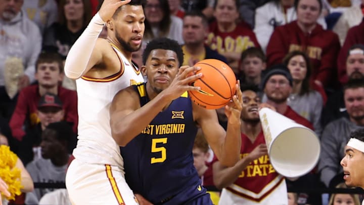 Jan 2, 2026; Ames, Iowa, USA; Iowa State Cyclones forward Joshua Jefferson (5) defends West Virginia Mountaineers guard Jasper Floyd (1)  during the first half at James H. Hilton Coliseum. Mandatory Credit: Reese Strickland-Imagn Images